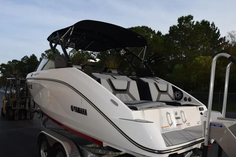Slide: The Image of 2026 Yamaha Boats 222XD on trailer, featuring sleek design and spacious seating. - 5