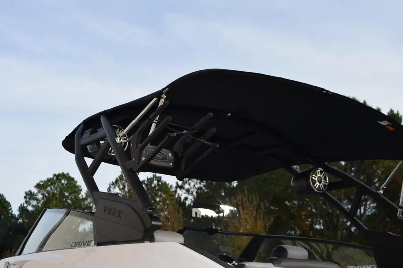 Slide: The Image of 2026 Yamaha Boats 222XD with black canopy and sleek design against a natural backdrop. - 6