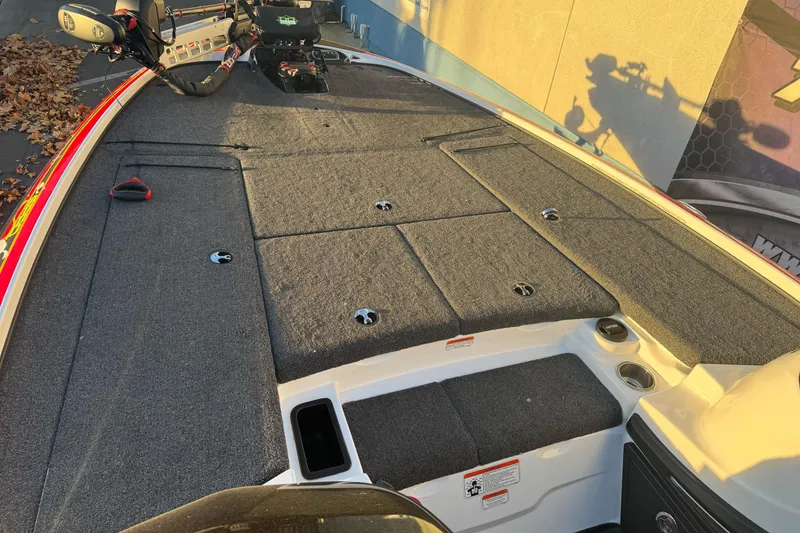 Slide: The Image of 2011 Nitro Z-9 DC boat deck with carpeted storage compartments and fishing seat. - 18