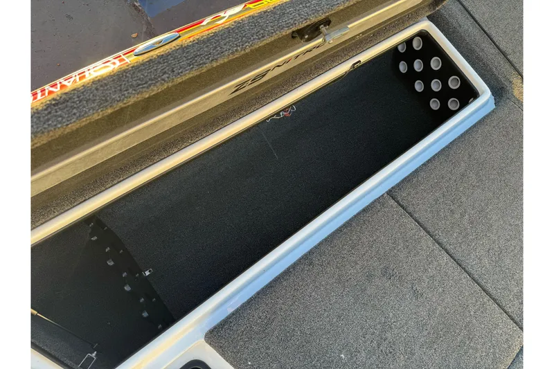Slide: The Image of Open storage compartment of 2011 Nitro Z-9 DC boat, featuring carpeted interior and rod holders. - 25