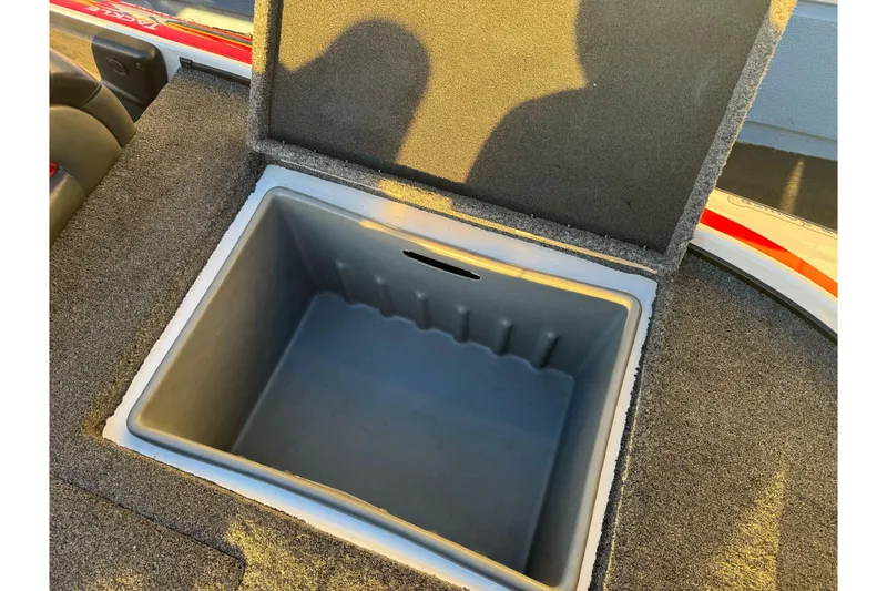 Slide: The Image of Open storage compartment in 2011 Nitro Z-9 DC boat, featuring carpeted interior. - 26