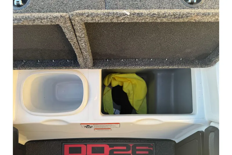 Slide: The Image of 2011 Nitro Z-9 DC boat storage compartments with yellow cloth and carpeted lids. - 28