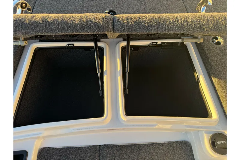 Slide: The Image of 2011 Nitro Z-9 DC boat storage compartments with open lids. - 29