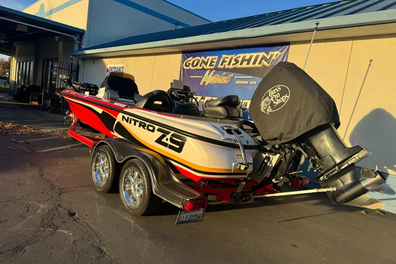 Slide: The Image of 2011 Nitro Z-9 DC boat with trailer, parked outside a fishing shop. - 4