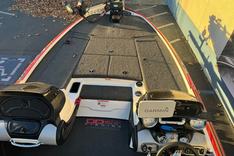 Slide: The Image of 2011 Nitro Z-9 DC boat with Garmin equipment, parked on a leaf-covered surface. - 9