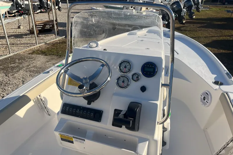 Slide: The Image of 2026 Key West 188 Bay Reef boat dashboard with steering wheel and gauges. - 11
