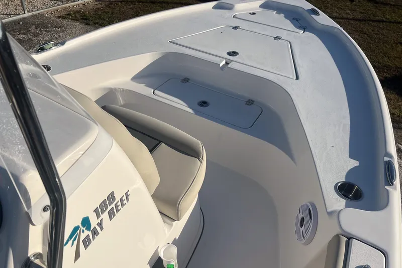 Slide: The Image of 2026 Key West 188 Bay Reef boat interior with seating and storage compartments. - 13