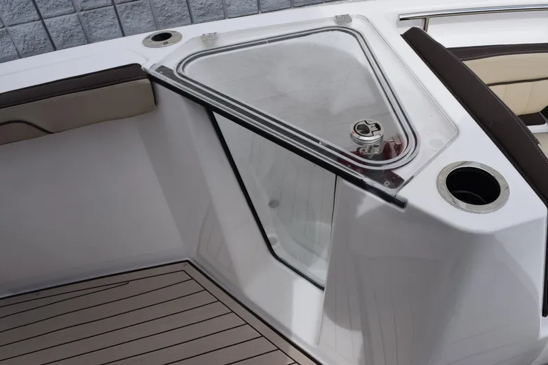 Slide: The Image of 2026 Yamaha Boats 255 FSH Sport H interior with seating and storage compartment. - 14