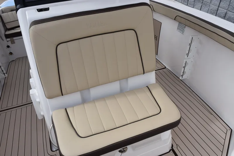 Slide: The Image of 2026 Yamaha Boats 255 FSH Sport H interior seating with beige upholstery and sleek design. - 15