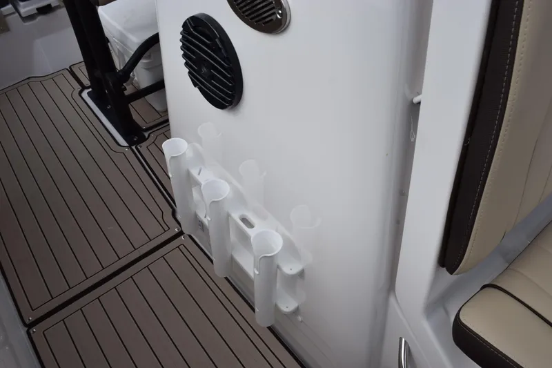 Slide: The Image of Yamaha Boats 2026 255 FSH Sport H interior with rod holders and speaker. - 22