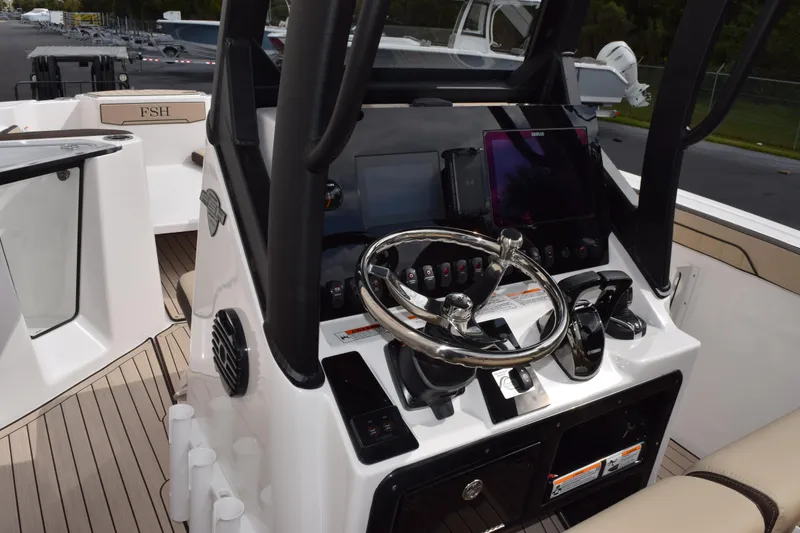 Slide: The Image of 2026 Yamaha Boats 255 FSH Sport H dashboard with steering wheel and controls. - 7