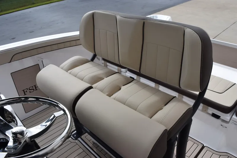 Slide: The Image of 2026 Yamaha Boats 255 FSH Sport H interior seating with steering wheel, showcasing luxury design. - 9