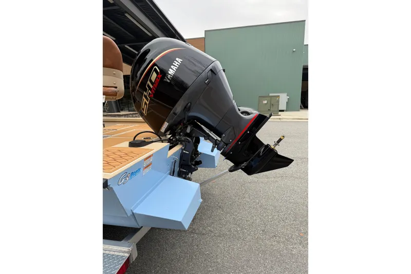 Slide: The Image of 2026 G3 Bay 21 GX boat with Yamaha outboard motor in a parking area. - 13