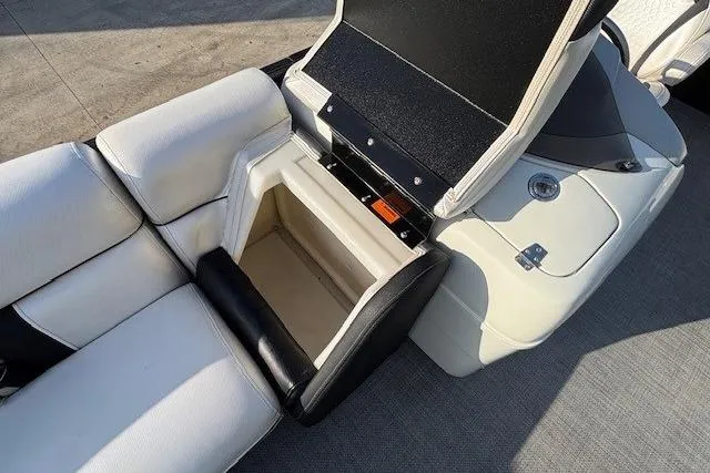 Slide: The Image of 2016 Southbay 523CR Super Sport Tri-Toon boat interior with open storage compartment. - 10