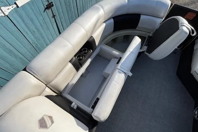 Slide: The Image of 2016 Southbay 523CR Super Sport Tri-Toon interior with storage and cup holders. - 12