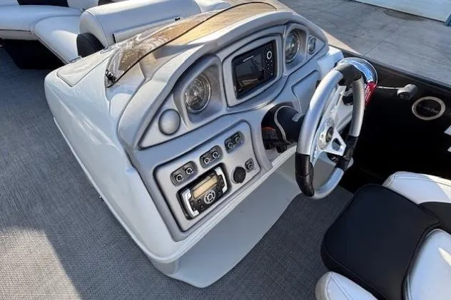 Slide: The Image of 2016 Southbay 523CR Super Sport Tri-Toon dashboard with steering wheel and control panel. - 18