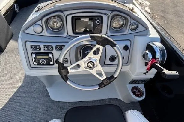 Slide: The Image of 2016 Southbay 523CR Super Sport Tri-Toon dashboard with steering wheel and controls. - 19