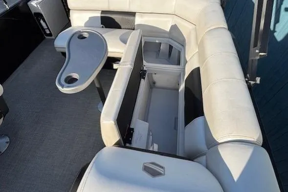 Slide: The Image of 2016 Southbay 523CR Super Sport Tri-Toon interior with open storage and table. - 23