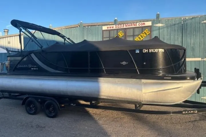 Slide: The Image of 2016 Southbay 523CR Super Sport Tri-Toon boat on trailer, covered and parked outdoors. - 32