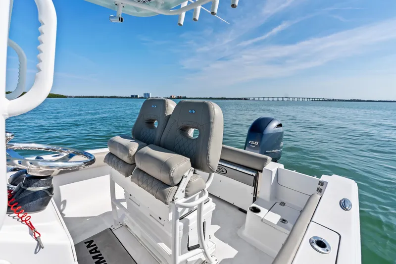 Slide: The Image of 2021 Sportsman Open 212 Center Console boat on calm water with clear sky. - 11