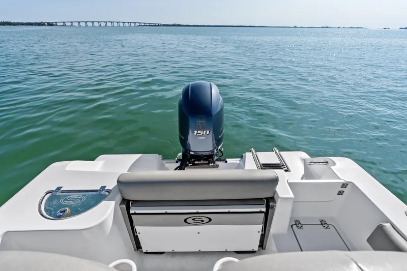Slide: The Image of 2021 Sportsman Open 212 Center Console boat on calm water with bridge in background. - 15