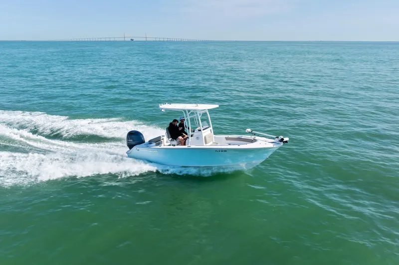 Slide: The Image of 2021 Sportsman Open 212 Center Console boat cruising on open water. - 2
