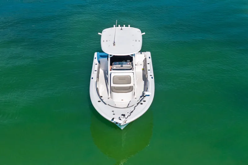 Slide: The Image of 2021 Sportsman Open 212 Center Console boat on clear green water. - 4