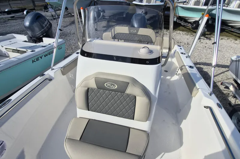 Slide: The Image of 2026 Key West 189 FS boat interior with cushioned seating and steering console. - 14