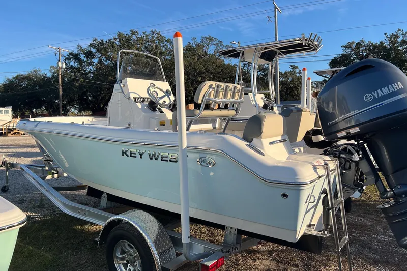 Slide: The Image of 2026 Key West 189 FS boat with Yamaha 115 engine, displayed outdoors. - 2