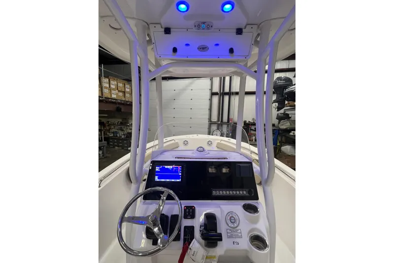 Slide: The Image of 2021 22 Tidewater Adventure boat console with steering wheel and navigation display. - 10
