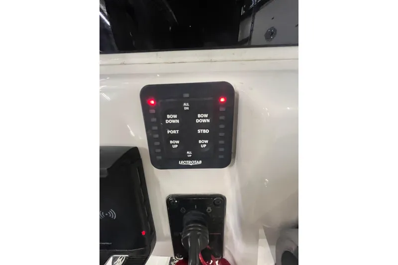 Slide: The Image of Control panel of a 2021 22 Tidewater Adventure boat with trim tab settings. - 12
