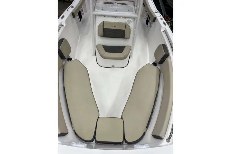 Slide: The Image of 2021 22 Tidewater Adventure boat interior with beige seating and white deck. - 16