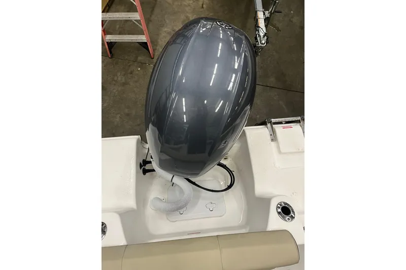 Slide: The Image of 2021 22 Tidewater Adventure boat engine, top view in a garage setting. - 20