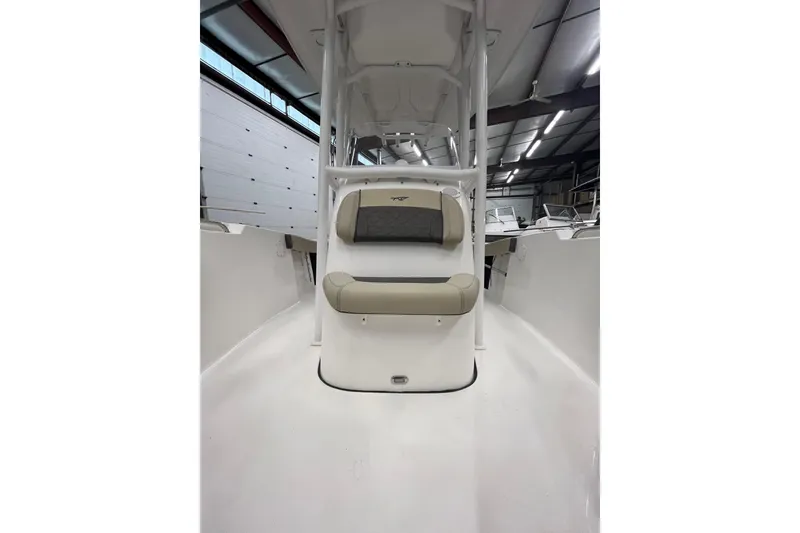 Slide: The Image of 2021 22 Tidewater Adventure boat interior with cushioned seating in a showroom. - 21