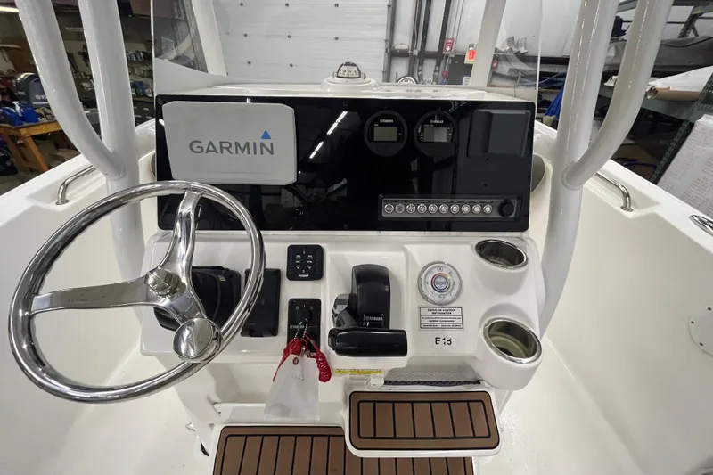 Slide: The Image of 2021 22 Tidewater Adventure boat dashboard with Garmin navigation system and Yamaha controls. - 24