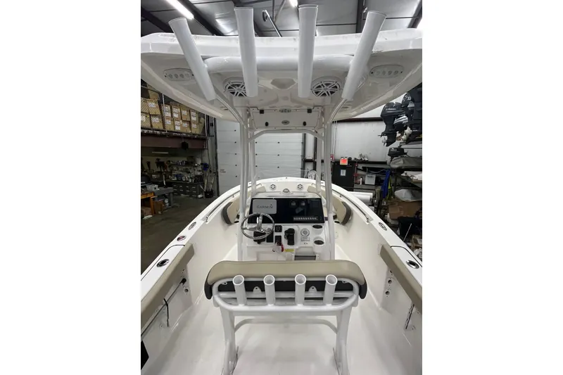Slide: The Image of 2021 22 Tidewater Adventure boat interior with steering console and rod holders. - 25