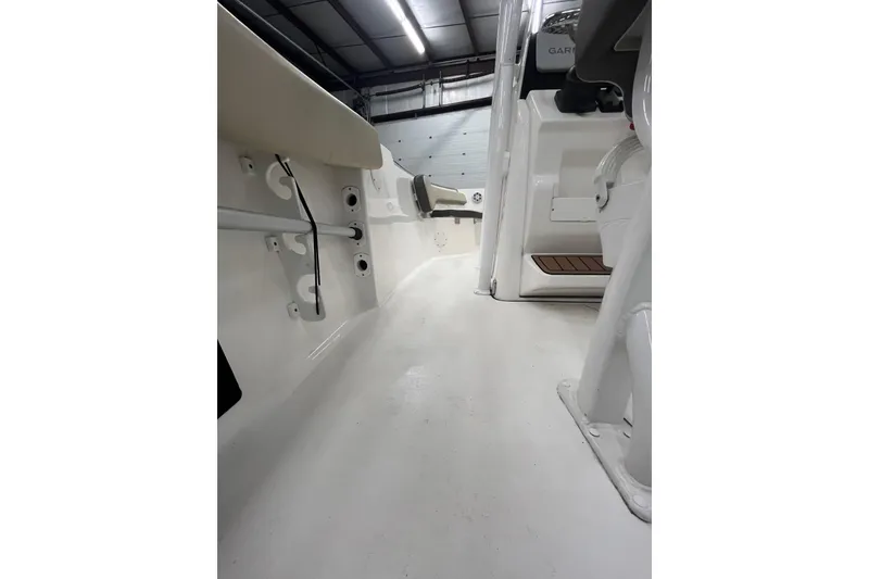Slide: The Image of Interior view of 2021 22 Tidewater Adventure boat, showcasing sleek white deck and seating. - 26