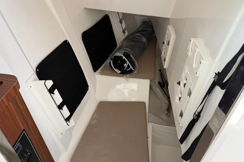 Slide: The Image of 2023 Pursuit DC 295 Dual Console cabin interior with seating and storage compartments. - 16