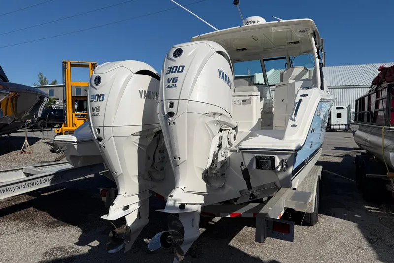 Slide: The Image of 2023 Pursuit DC 295 Dual Console boat with twin Yamaha 300 V6 engines on trailer. - 17