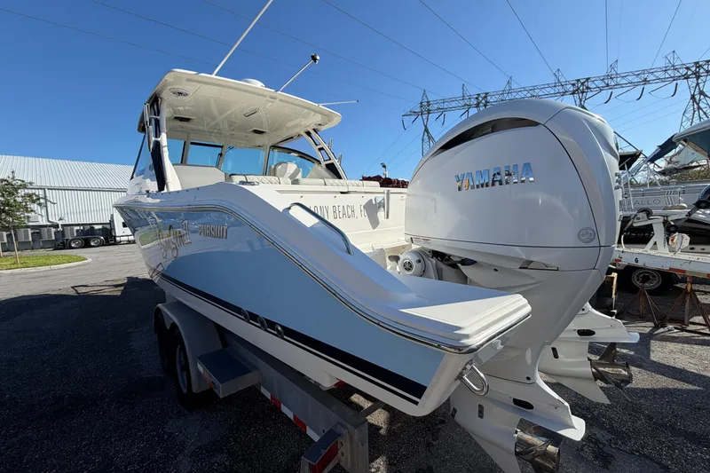 Slide: The Image of 2023 Pursuit DC 295 Dual Console boat with Yamaha engines on a trailer. - 5
