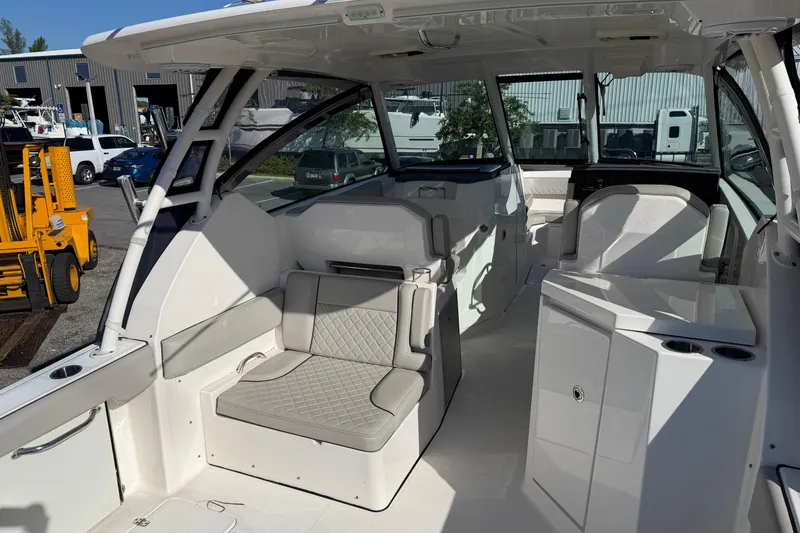 Slide: The Image of 2023 Pursuit DC 295 Dual Console boat interior with seating and storage compartments. - 7