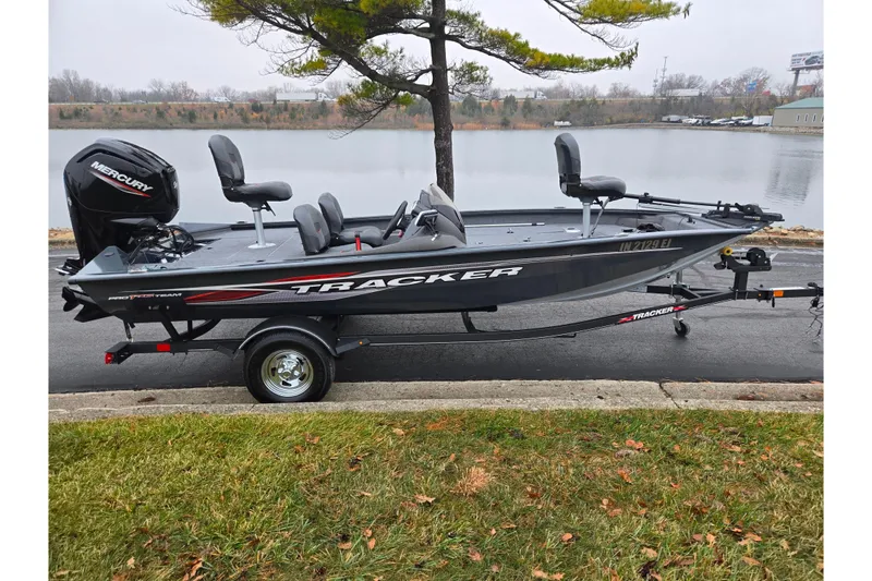 Slide: The Image of 2022 Tracker Pro Team 175 TF fishing boat on trailer by a lake. - 10