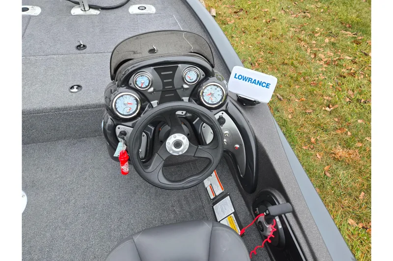 Slide: The Image of 2022 Tracker Pro Team 175 TF boat dashboard with Lowrance fishfinder and steering wheel. - 12