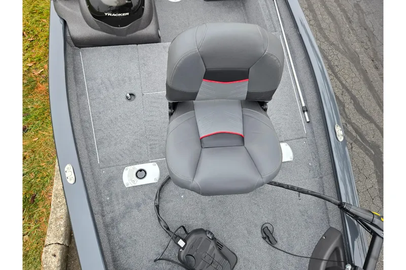 Slide: The Image of 2022 Tracker Pro Team 175 TF boat interior with gray seating and fishing equipment. - 18