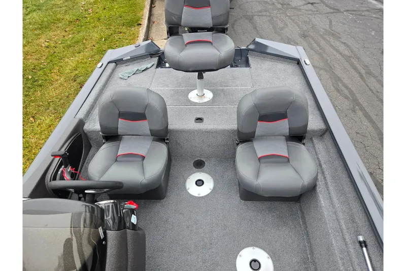 Slide: The Image of 2022 Tracker Pro Team 175 TF boat interior with gray seating and steering wheel. - 20