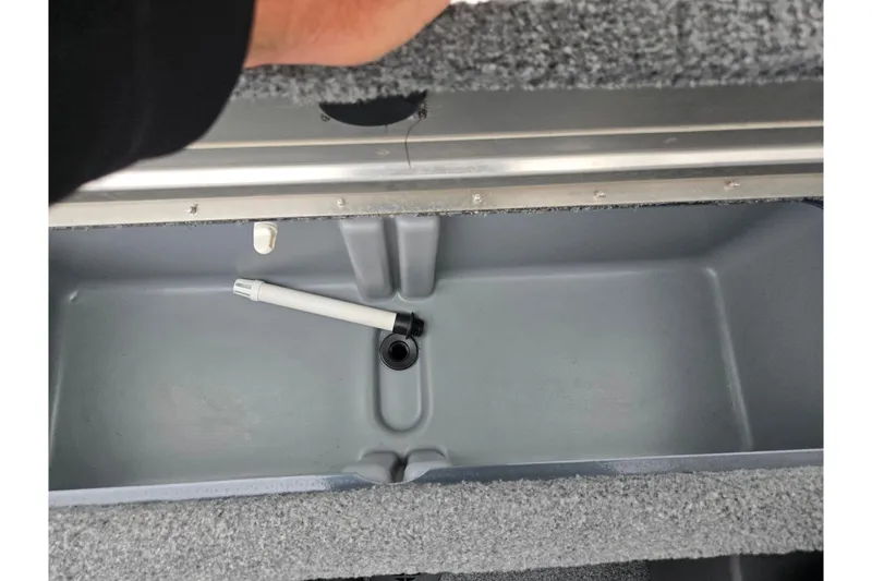Slide: The Image of 2022 Tracker Pro Team 175 TF storage compartment with a drain plug. - 22