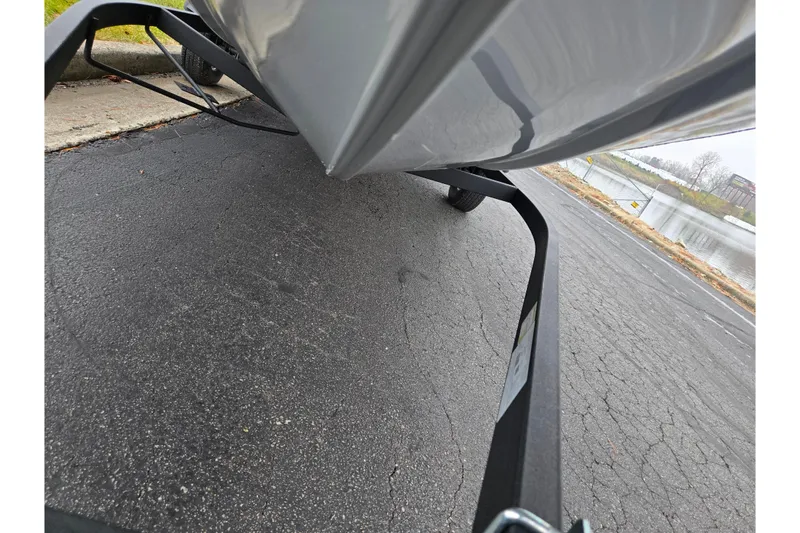 Slide: The Image of 2022 Tracker Pro Team 175 TF boat on trailer near a lake. - 8