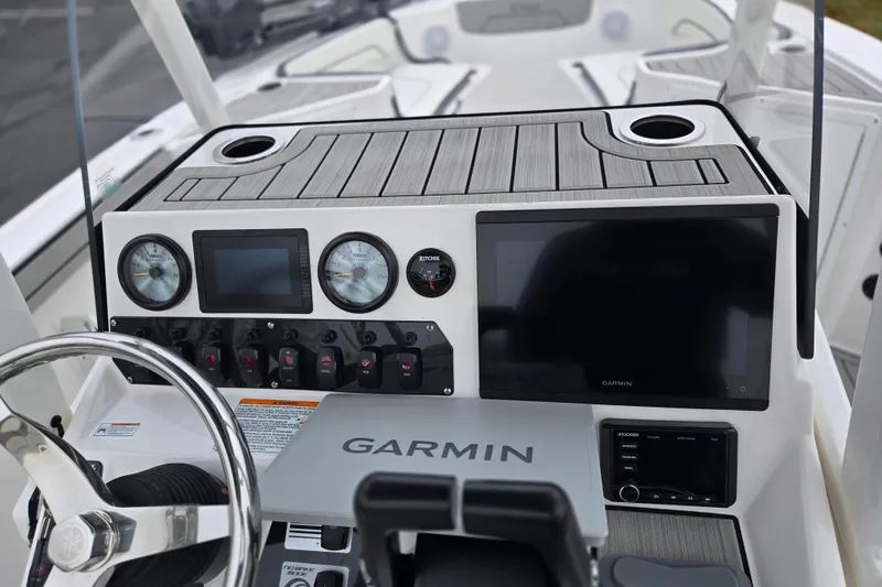 Slide: The Image of 2022 Yamaha Boats 210 FSH Sport dashboard with Garmin navigation system and controls. - 13