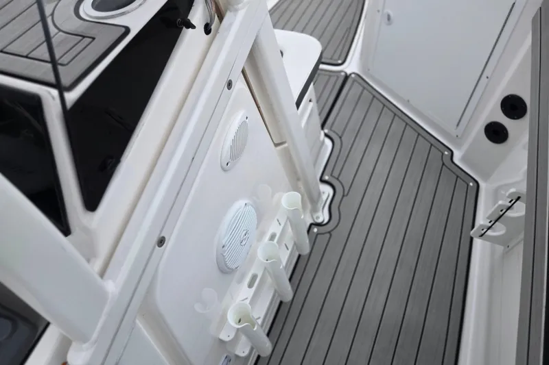 Slide: The Image of 2022 Yamaha Boats 210 FSH Sport interior with sleek deck and rod holders. - 14