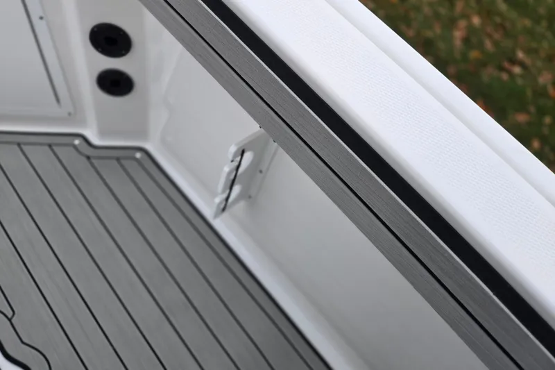 Slide: The Image of 2022 Yamaha Boats 210 FSH Sport deck with sleek, modern design and durable flooring. - 15